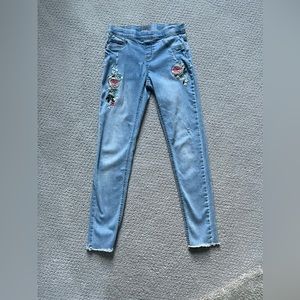 Justice mid rise jean leggings with floral accents.